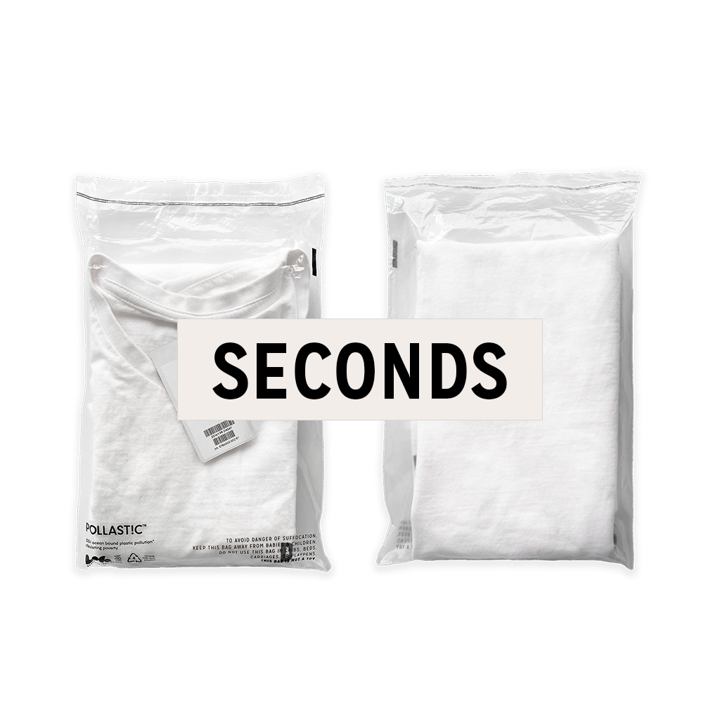 Front and back of a transparent Better Packaging POLLAST!C poly garment bag, containing a white tee shirt with graphic label &quot;Seconds&quot; over it on a transparent background